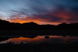 Sunset over the mountains at Awaroa Hut