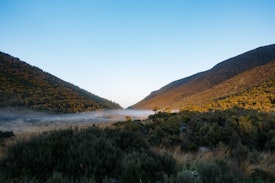 Mist runs across the pass at Perry Saddle Hut