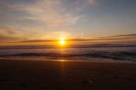 A view along Heaphy Beach in the sunset