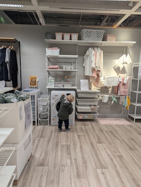 Jack standing in front of a washing machine at Ikea